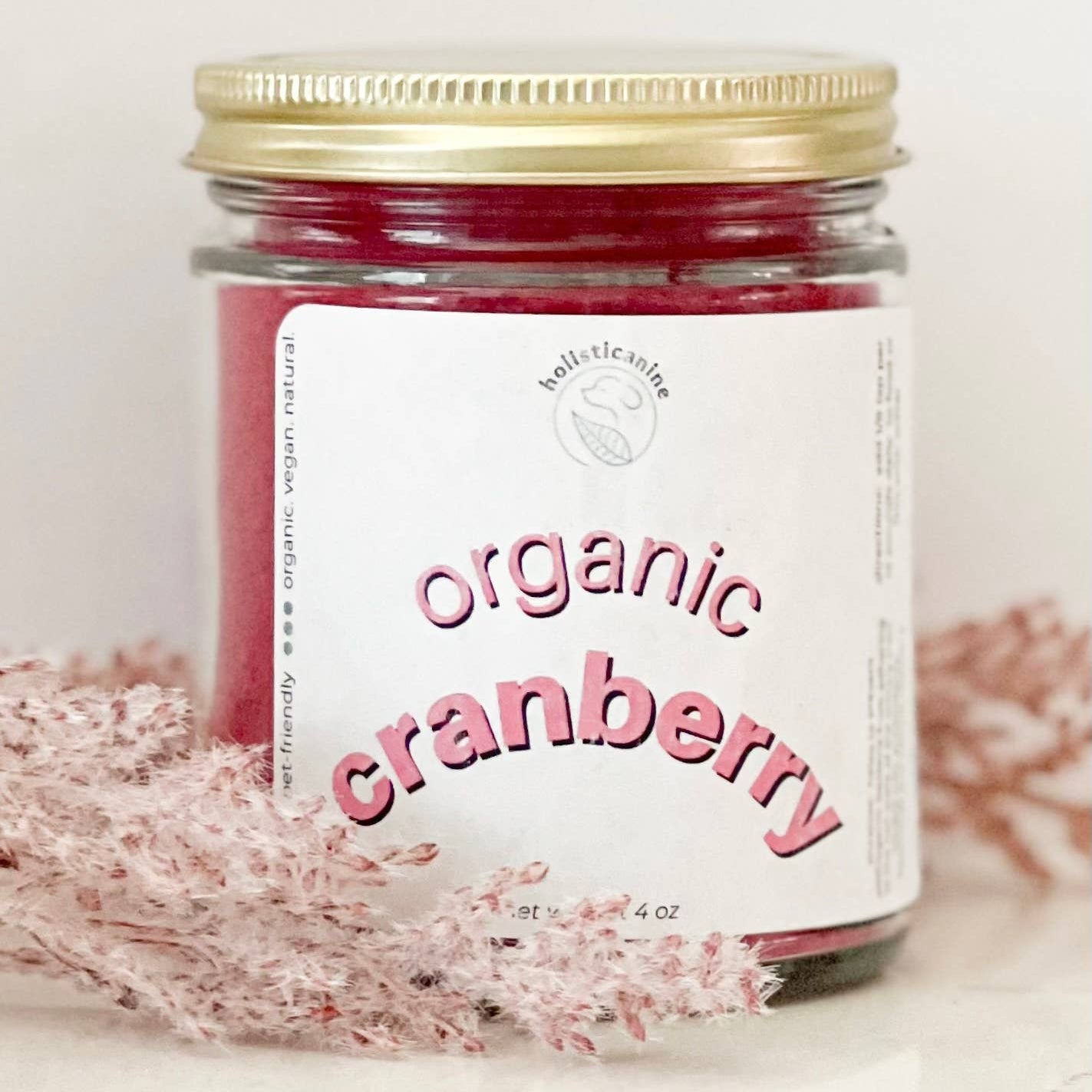 Jar of organic cranberry product with a gold lid on a light background
