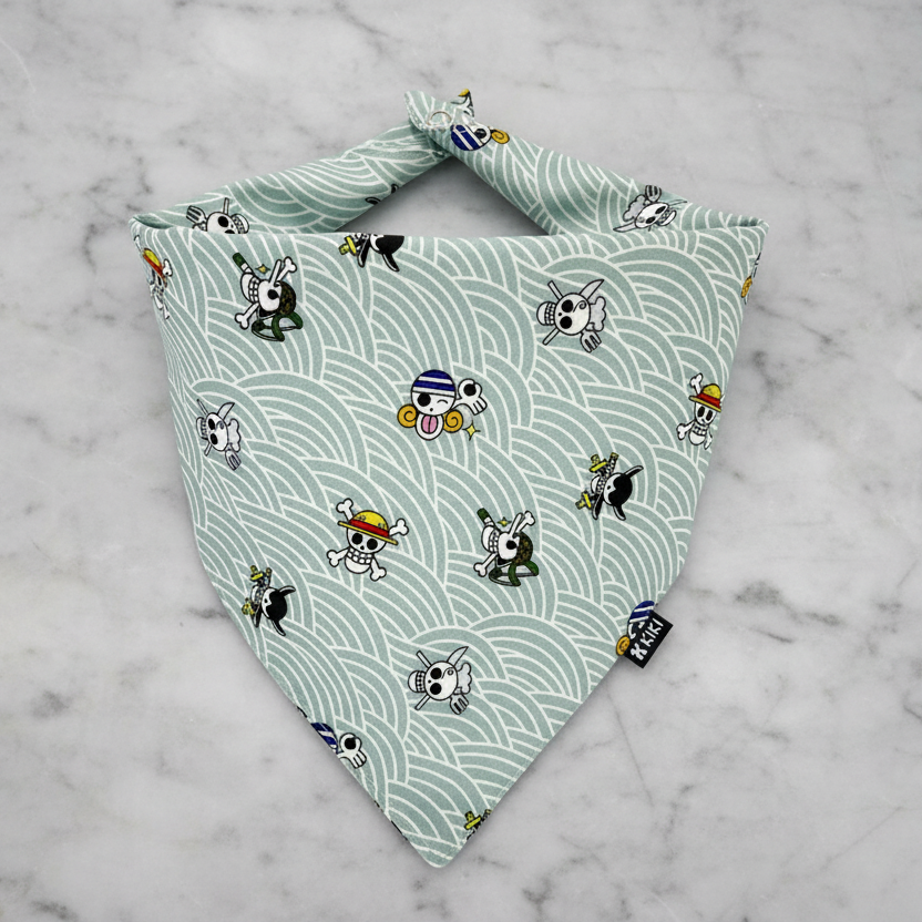 Dog bandana with cartoon character pattern on a light green background
