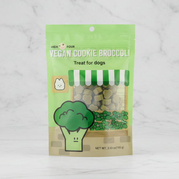 Green package of Vegan Cookie Broccoli dog treats on a white background