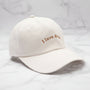 Beige cap with 'I love dogs' embroidery on a light gray background