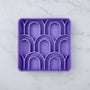 Purple silicone bowl with geometric design on a light purple background