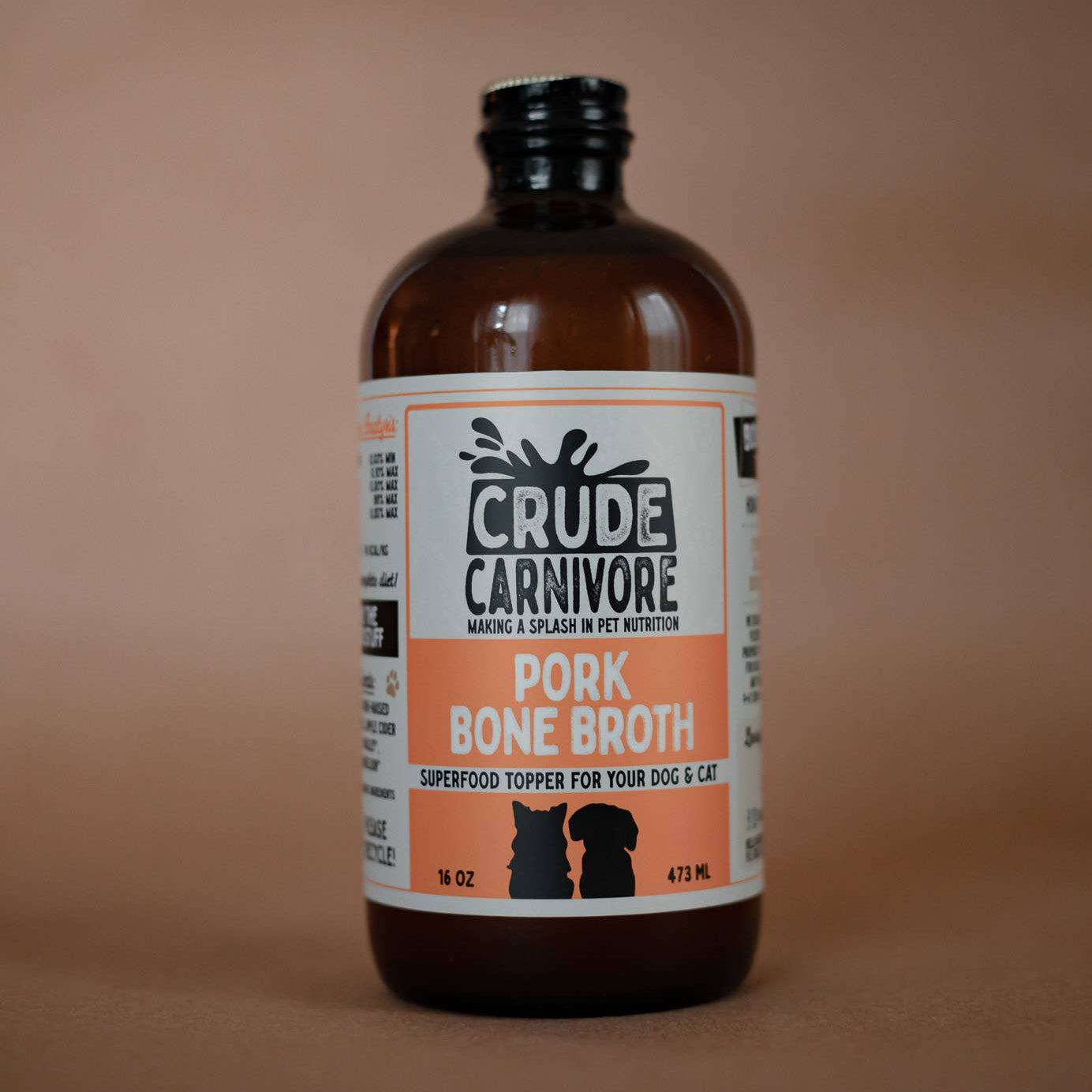 Bottle of Crude Carnivore pork bone broth on a brown background