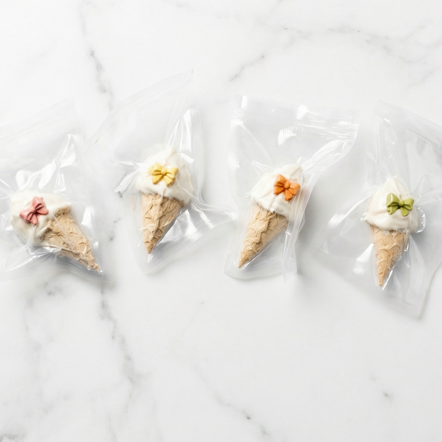 Ice cream cones in clear plastic bags on a marble surface