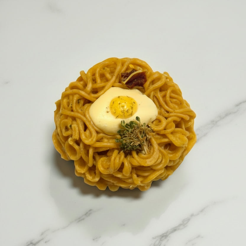 Noodle ball with egg and green herb on a marble surface