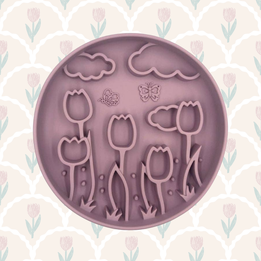 Purple silicone mold with floral designs on a patterned background