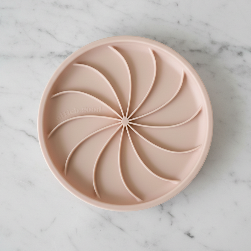 Round silicone mold with a swirled design on a white background